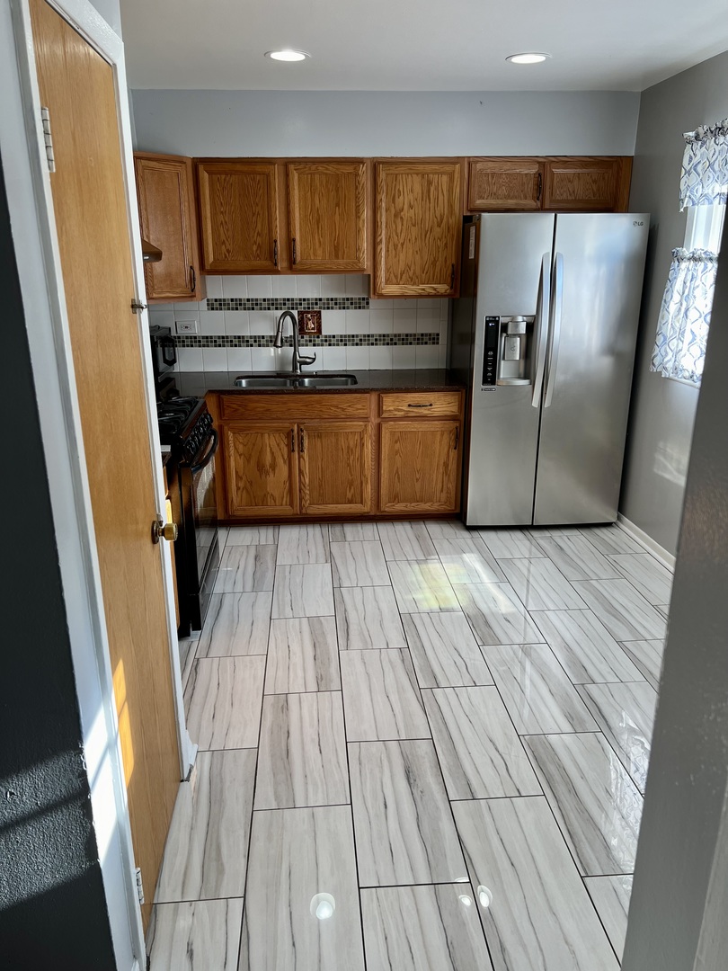 9559 Sumac Road, Unit F Des Plaines, IL 60016 - Photo 8 of 24 view of kitchen with wooden floor and electronic appliances