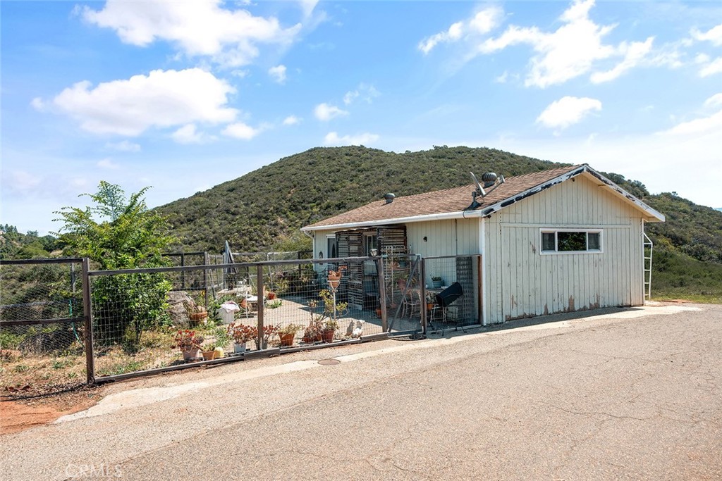1996 Rainbow Glen Fallbrook, CA 92028 - Photo 21 of 55 a view of a house with a backyard