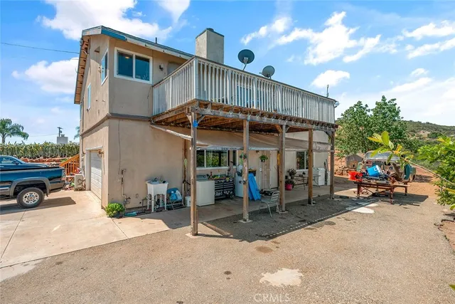a view of a terrace with furniture and a garden