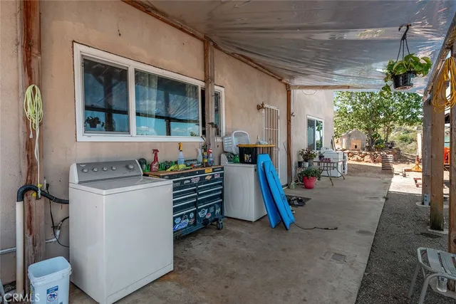 a open kitchen with stainless steel appliances granite countertop a stove top oven a sink dishwasher and cabinets with wooden floor