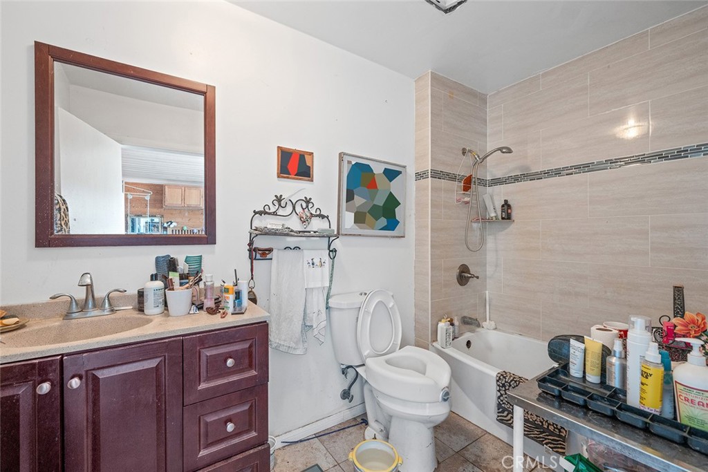 1996 Rainbow Glen Fallbrook, CA 92028 - Photo 40 of 55 a bathroom with a toilet a sink and a mirror
