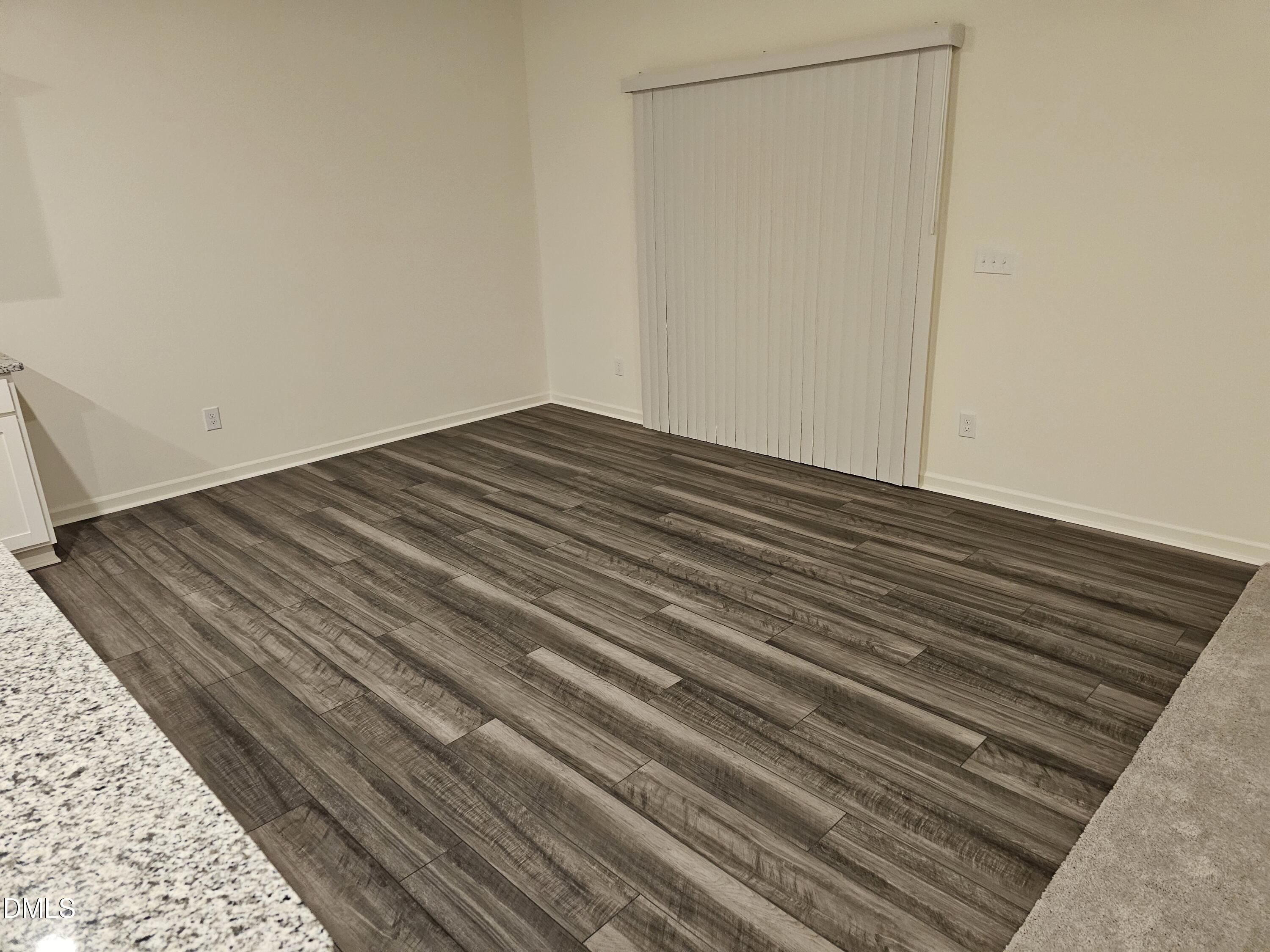 1253 Solace Way Rolesville, NC 27571 - Photo 11 of 31 a view of a room with wooden floor