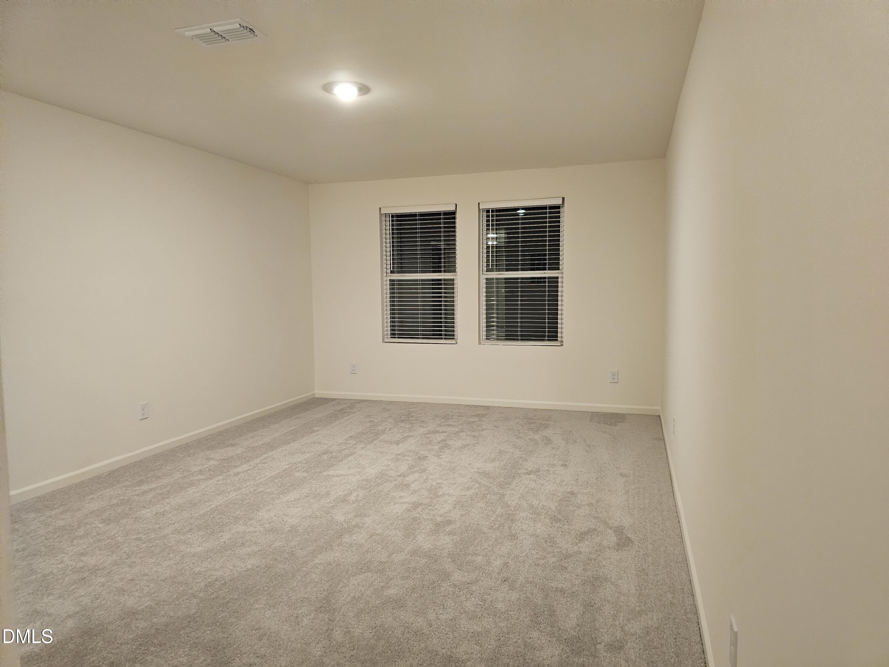1253 Solace Way Rolesville, NC 27571 - Photo 19 of 31 an empty room with windows