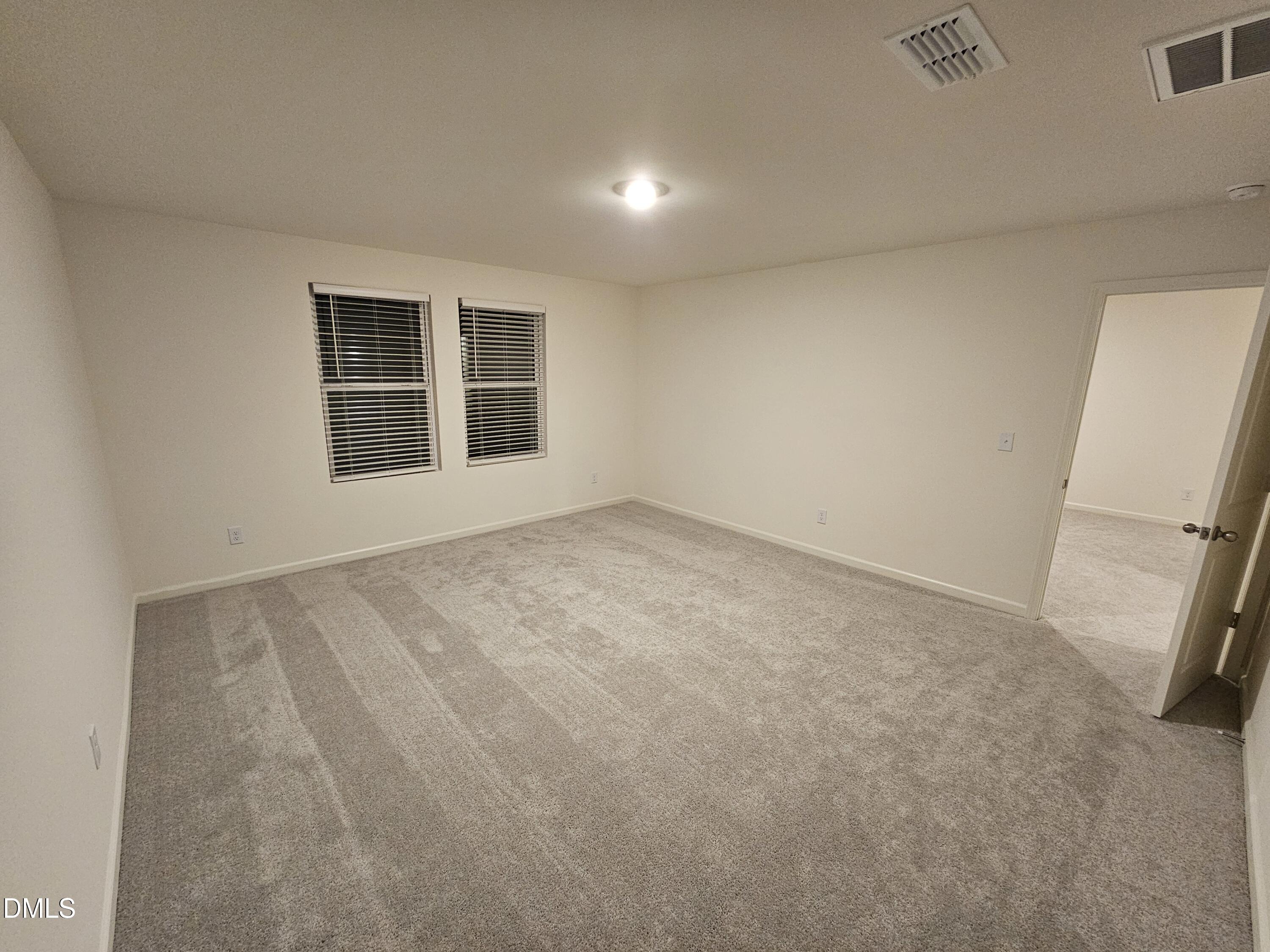 1253 Solace Way Rolesville, NC 27571 - Photo 21 of 31 an empty room with windows