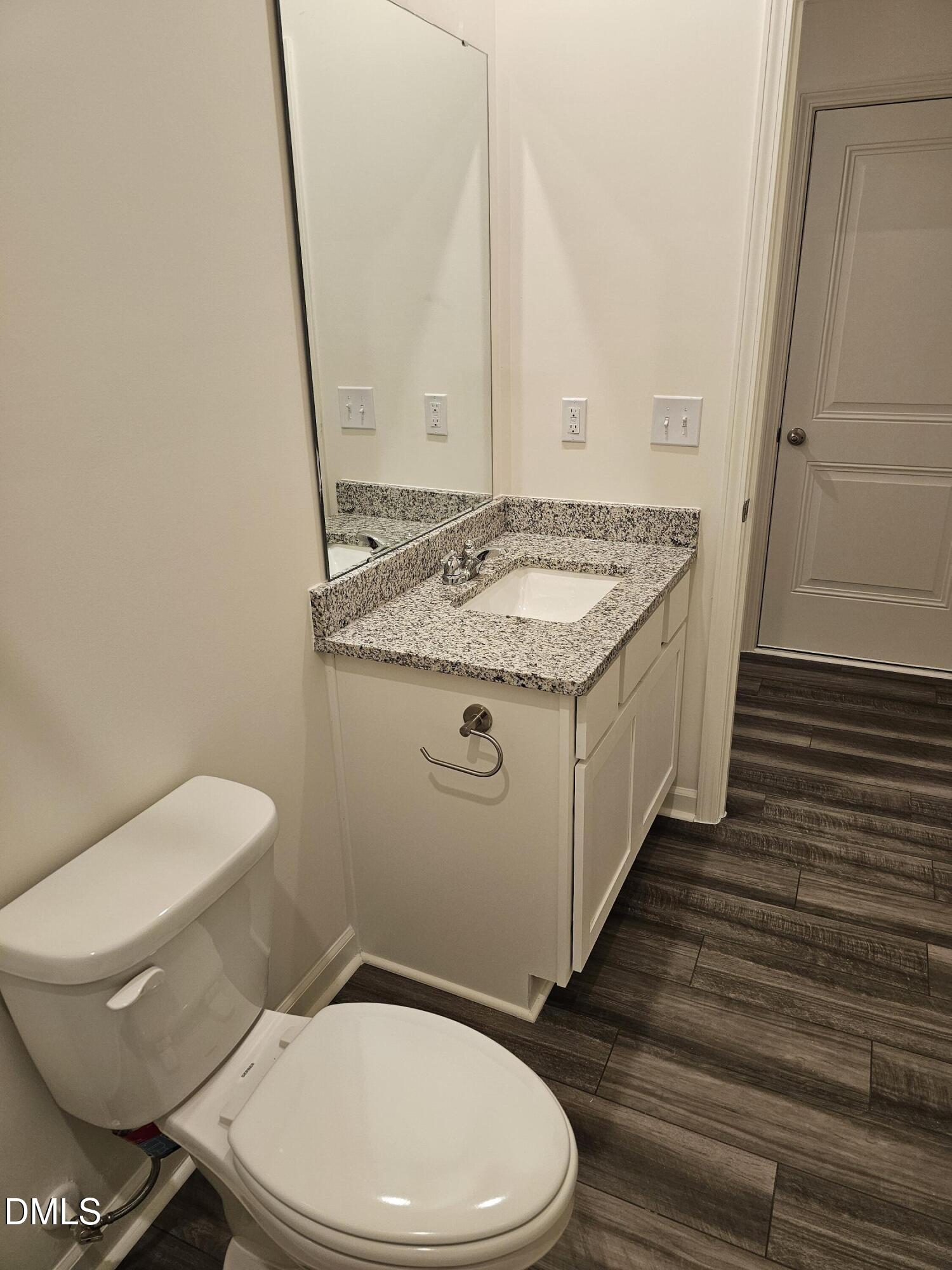 1253 Solace Way Rolesville, NC 27571 - Photo 22 of 31 a bathroom with a granite countertop toilet and a sink