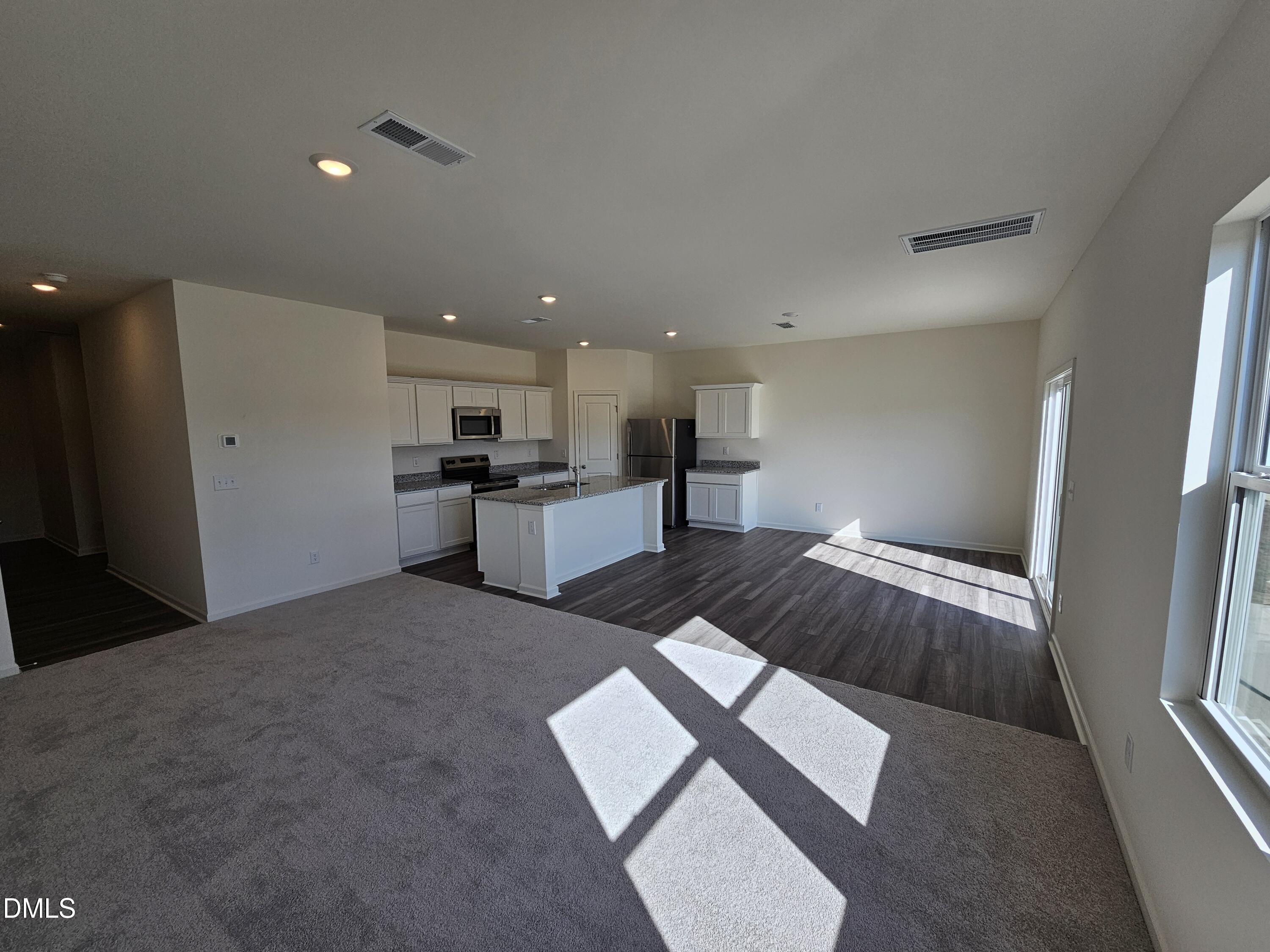 1253 Solace Way Rolesville, NC 27571 - Photo 7 of 31 a large white kitchen with stainless steel appliances granite countertop a refrigerator and a sink