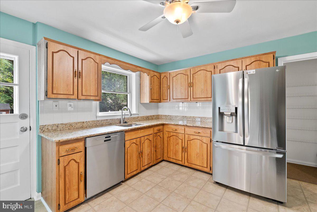 919 Ednor Road Silver Spring, MD 20905 - Photo 11 of 29 a kitchen with stainless steel appliances granite countertop a refrigerator sink and cabinets