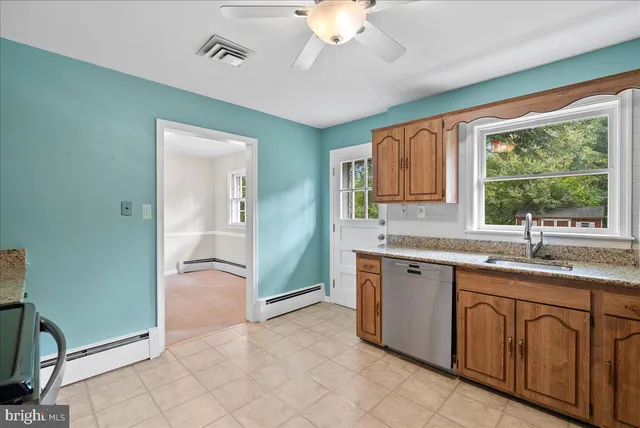 a spacious bathroom with a granite countertop sink a mirror and a bathtub with shower