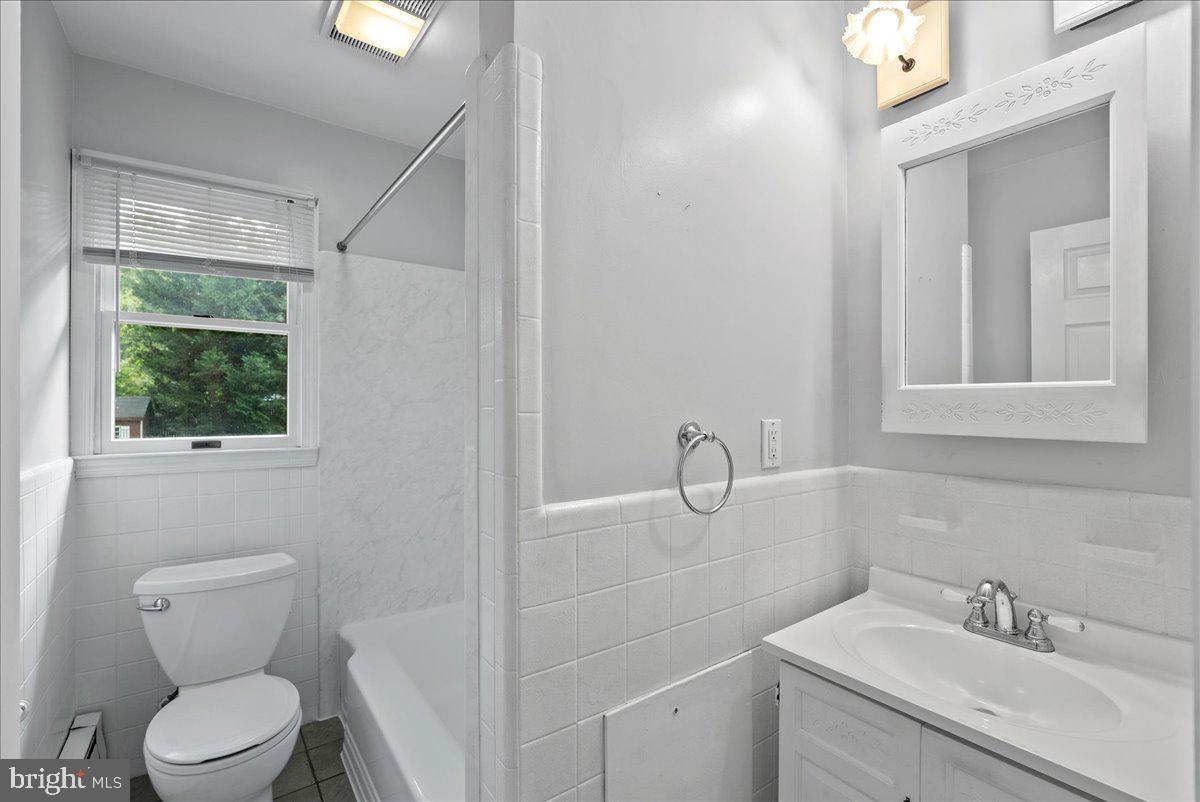 919 Ednor Road Silver Spring, MD 20905 - Photo 14 of 29 a bathroom with a toilet sink and window