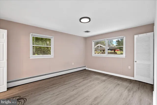 a view of a livingroom with wooden floor and window