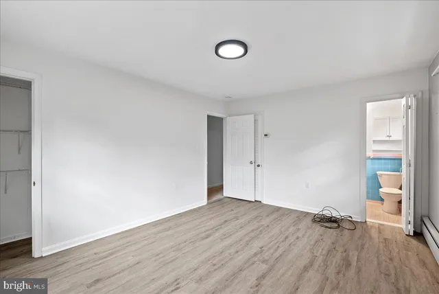 a view of an empty room and wooden floor