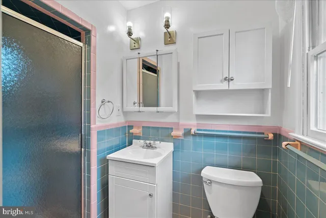 a bathroom with a toilet sink and mirror