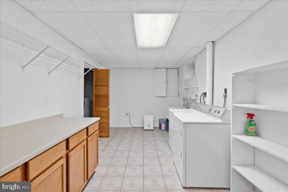 919 Ednor Road Silver Spring, MD 20905 - Photo 22 of 29 a utility room with cabinets washer and dryer