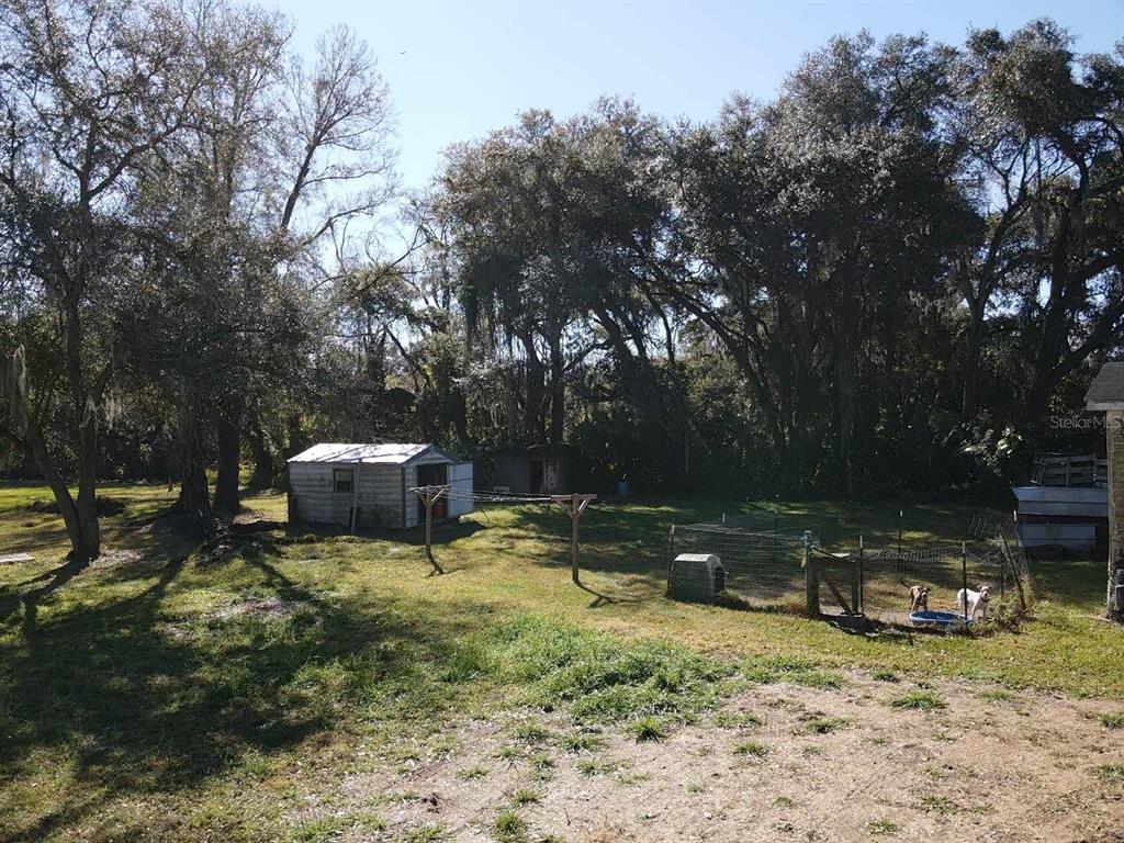 5614 Watson Road Riverview, FL 33578 - Photo 13 of 29 a backyard of a house with barbeque oven and outdoor seating