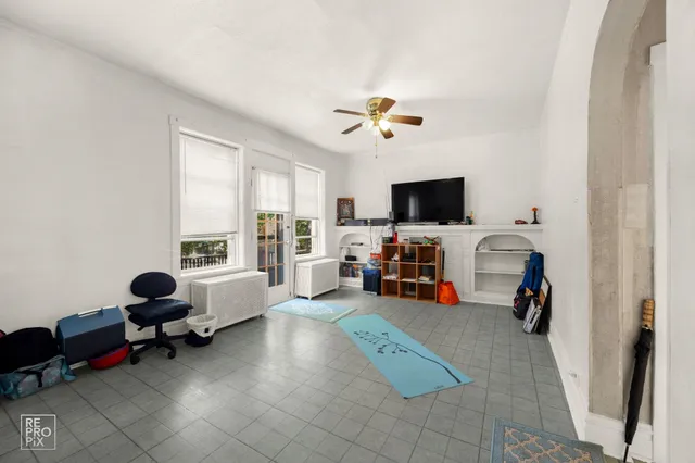 a view of a livingroom with workspace and a window