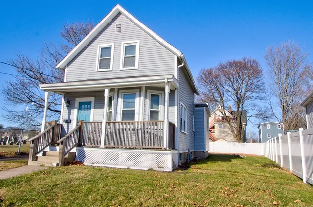 a view of a house with yard and sitting area