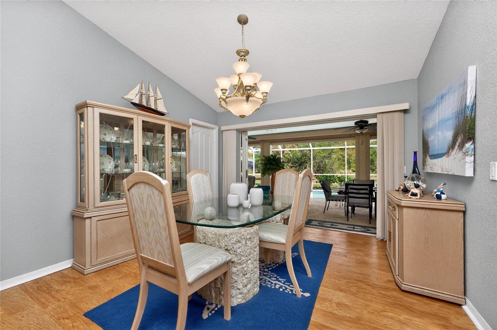 100 Angol Street Punta Gorda, FL 33983 - Photo 11 of 56 a view of a dining room with furniture a chandelier and wooden floor