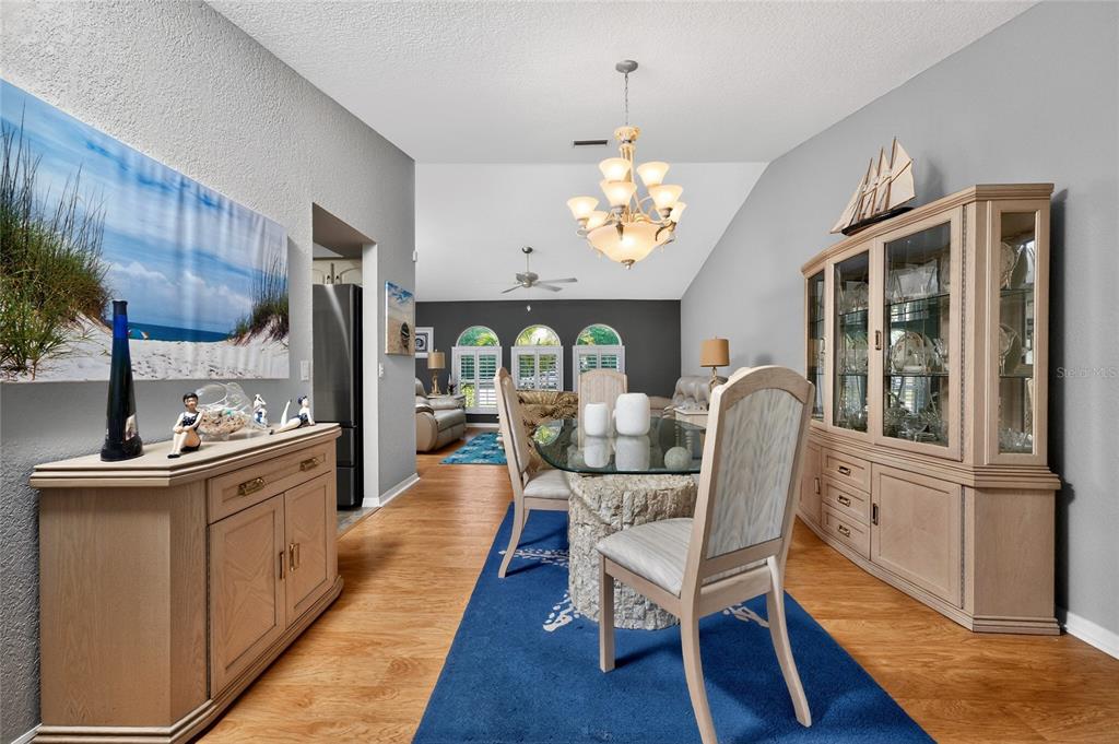 100 Angol Street Punta Gorda, FL 33983 - Photo 13 of 56 a view of a dining room with furniture a chandelier and wooden floor