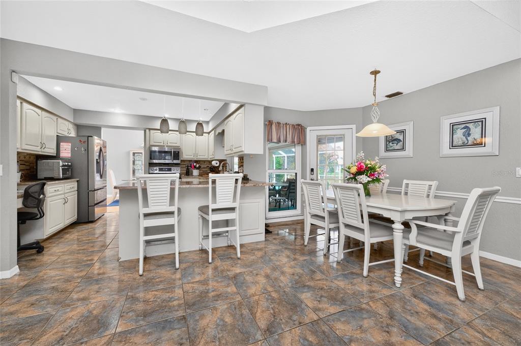 100 Angol Street Punta Gorda, FL 33983 - Photo 15 of 56 a dining room with furniture a chandelier and kitchen view