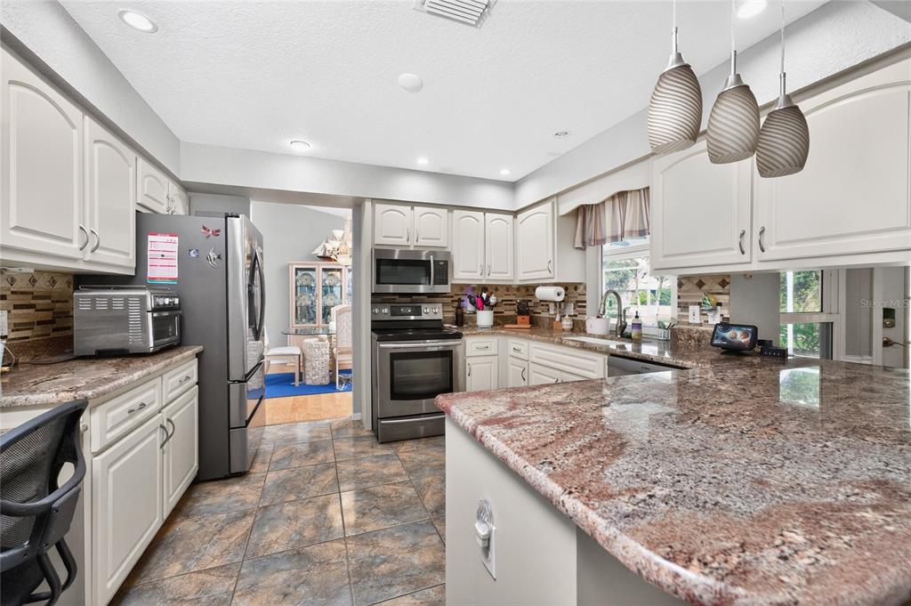 100 Angol Street Punta Gorda, FL 33983 - Photo 17 of 56 a kitchen with stainless steel appliances granite countertop a sink stove and refrigerator