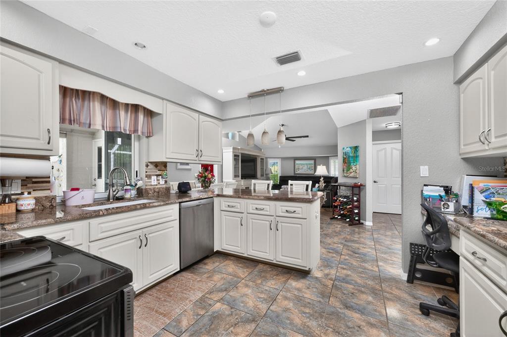 100 Angol Street Punta Gorda, FL 33983 - Photo 19 of 56 a kitchen with sink cabinets and stove top oven