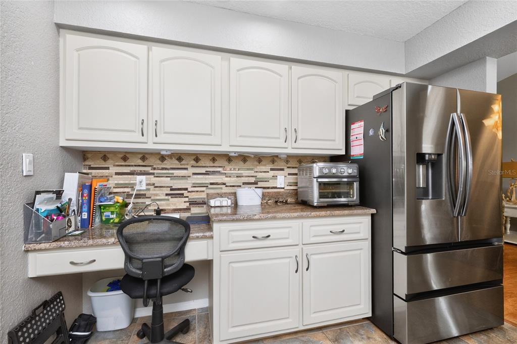 100 Angol Street Punta Gorda, FL 33983 - Photo 22 of 56 a kitchen with stainless steel appliances granite countertop a refrigerator sink and cabinets