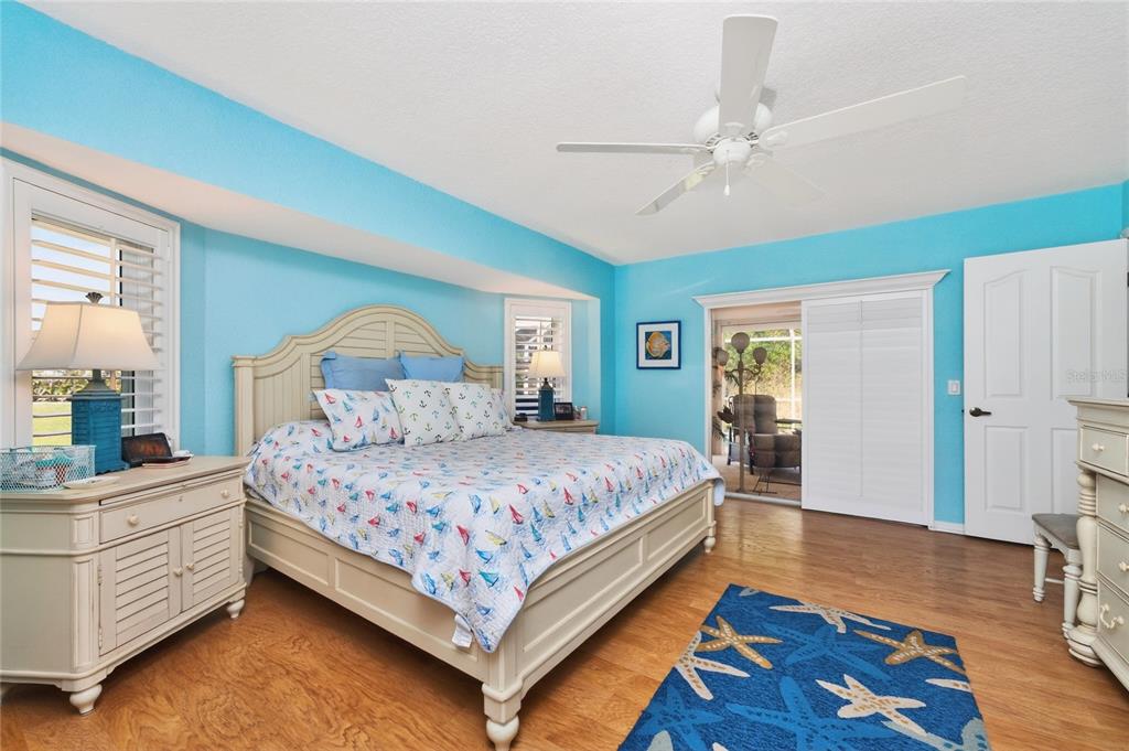 100 Angol Street Punta Gorda, FL 33983 - Photo 29 of 56 a bedroom with a bed and a dresser with wooden floor