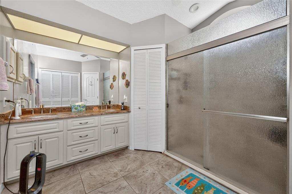 100 Angol Street Punta Gorda, FL 33983 - Photo 32 of 56 a spacious bathroom with a granite countertop sink a mirror and a shower
