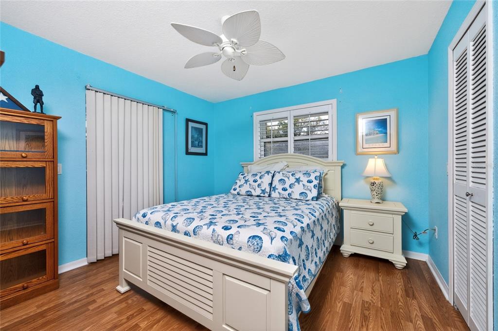 100 Angol Street Punta Gorda, FL 33983 - Photo 33 of 56 a bedroom with a bed and a chandelier