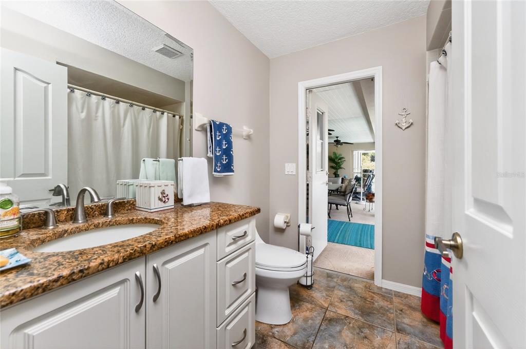 100 Angol Street Punta Gorda, FL 33983 - Photo 35 of 56 a bathroom with a granite countertop sink mirror vanity and toilet