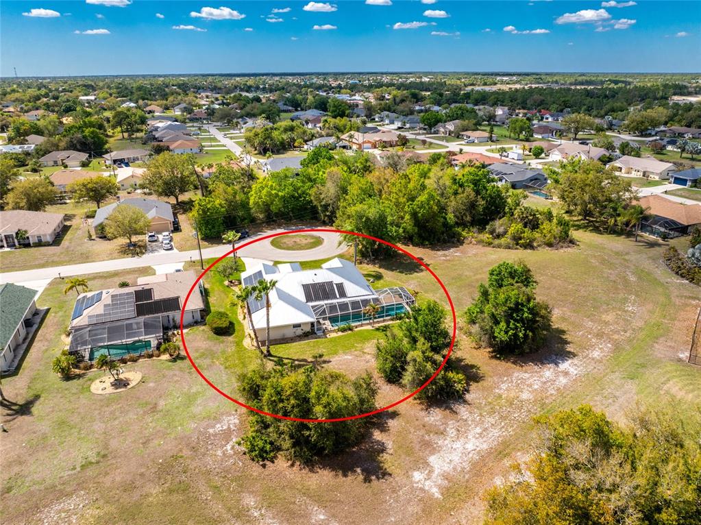 100 Angol Street Punta Gorda, FL 33983 - Photo 50 of 56 a view of a swimming pool with a yard and mountain in the background