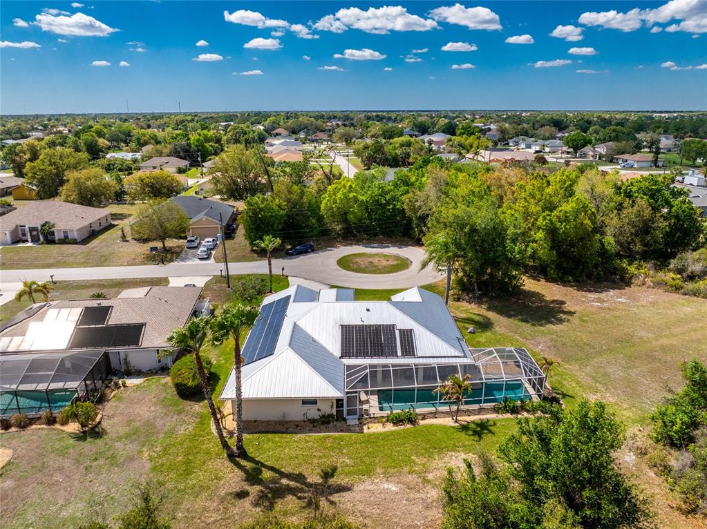 100 Angol Street Punta Gorda, FL 33983 - Photo 51 of 56 a view of a swimming pool with lawn chairs under an umbrella with wooden floor