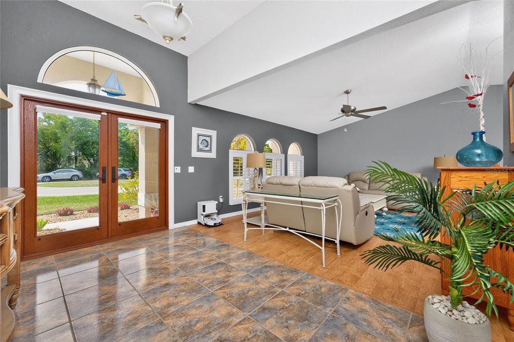 100 Angol Street Punta Gorda, FL 33983 - Photo 6 of 56 a living room with furniture a chandelier and a large window