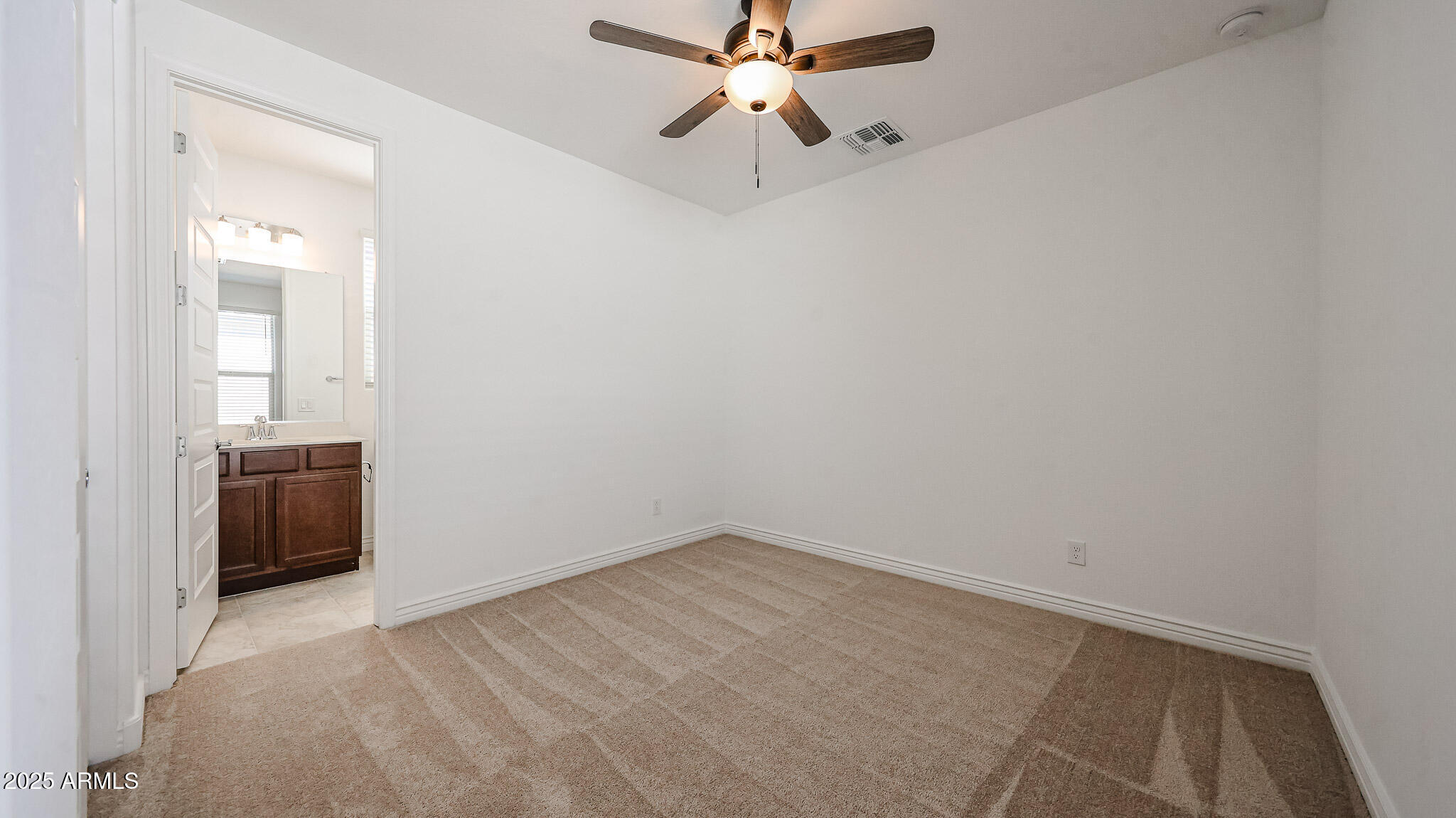 25051 North 171st Avenue Surprise, AZ 85387 - Photo 13 of 19 a view of a room with a ceiling fan and a stove