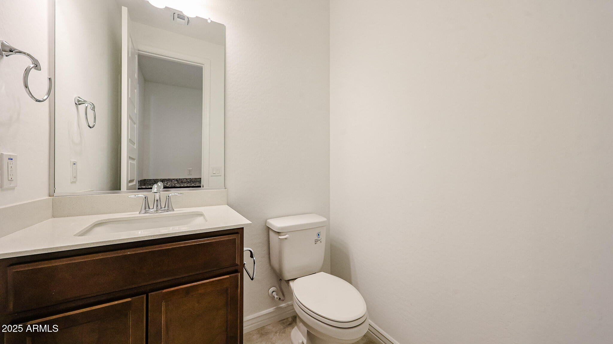25051 North 171st Avenue Surprise, AZ 85387 - Photo 15 of 19 a bathroom with a sink a toilet a mirror and vanity