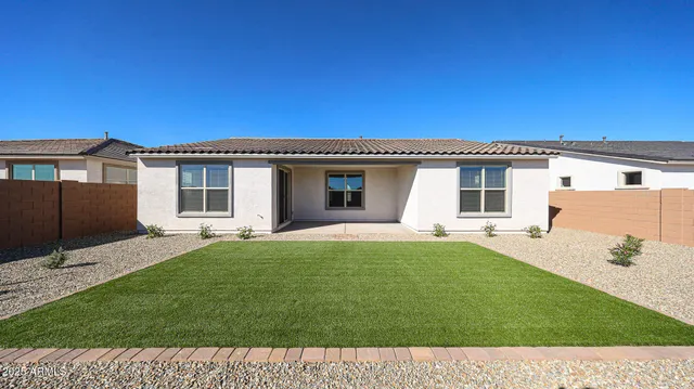 a view of a house with a backyard