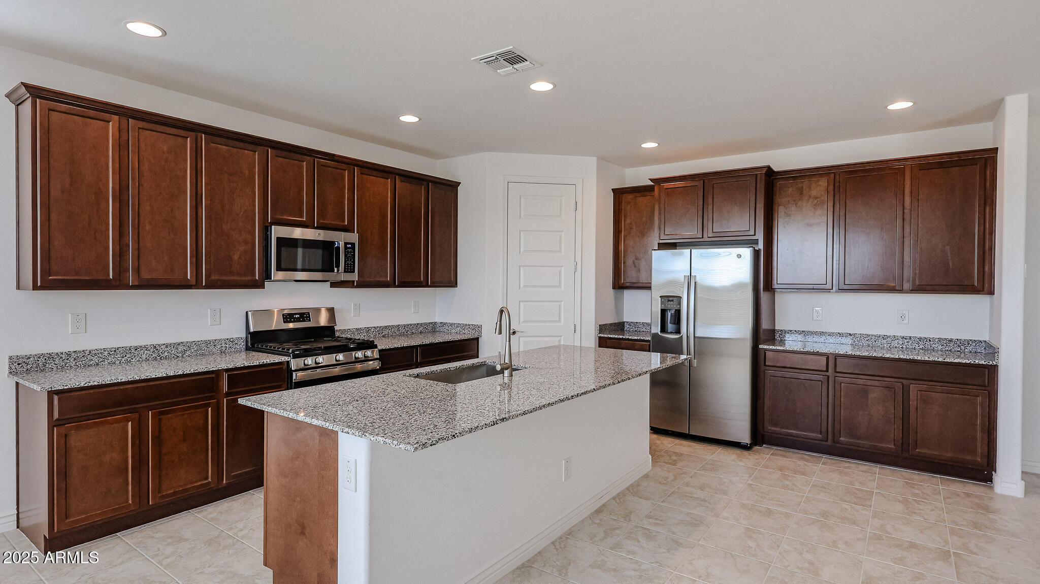 25051 North 171st Avenue Surprise, AZ 85387 - Photo 2 of 19 a kitchen with granite countertop stainless steel appliances and wooden cabinets