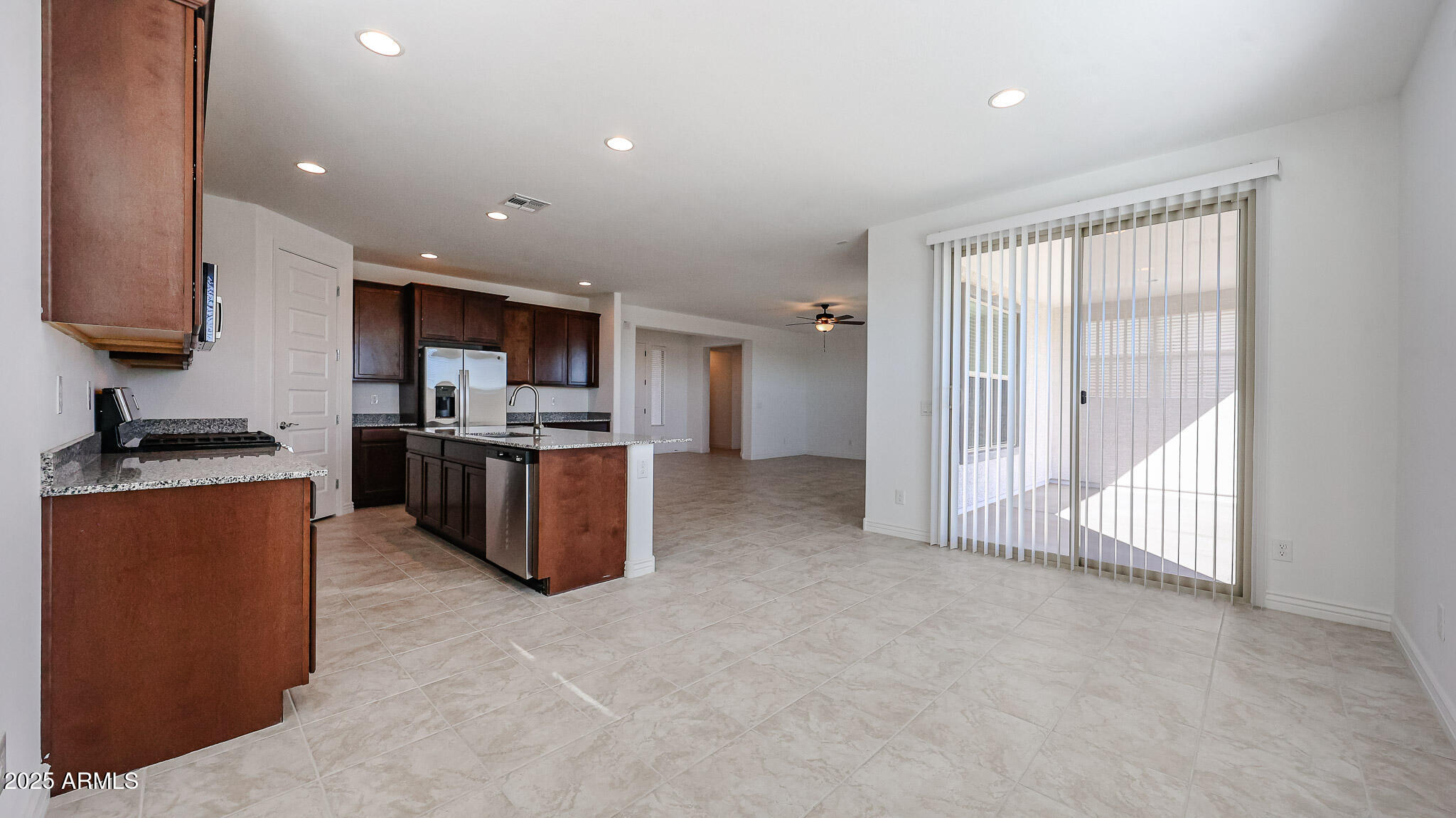 25051 North 171st Avenue Surprise, AZ 85387 - Photo 4 of 19 a large kitchen with stainless steel appliances granite countertop a stove top oven a sink and a refrigerator