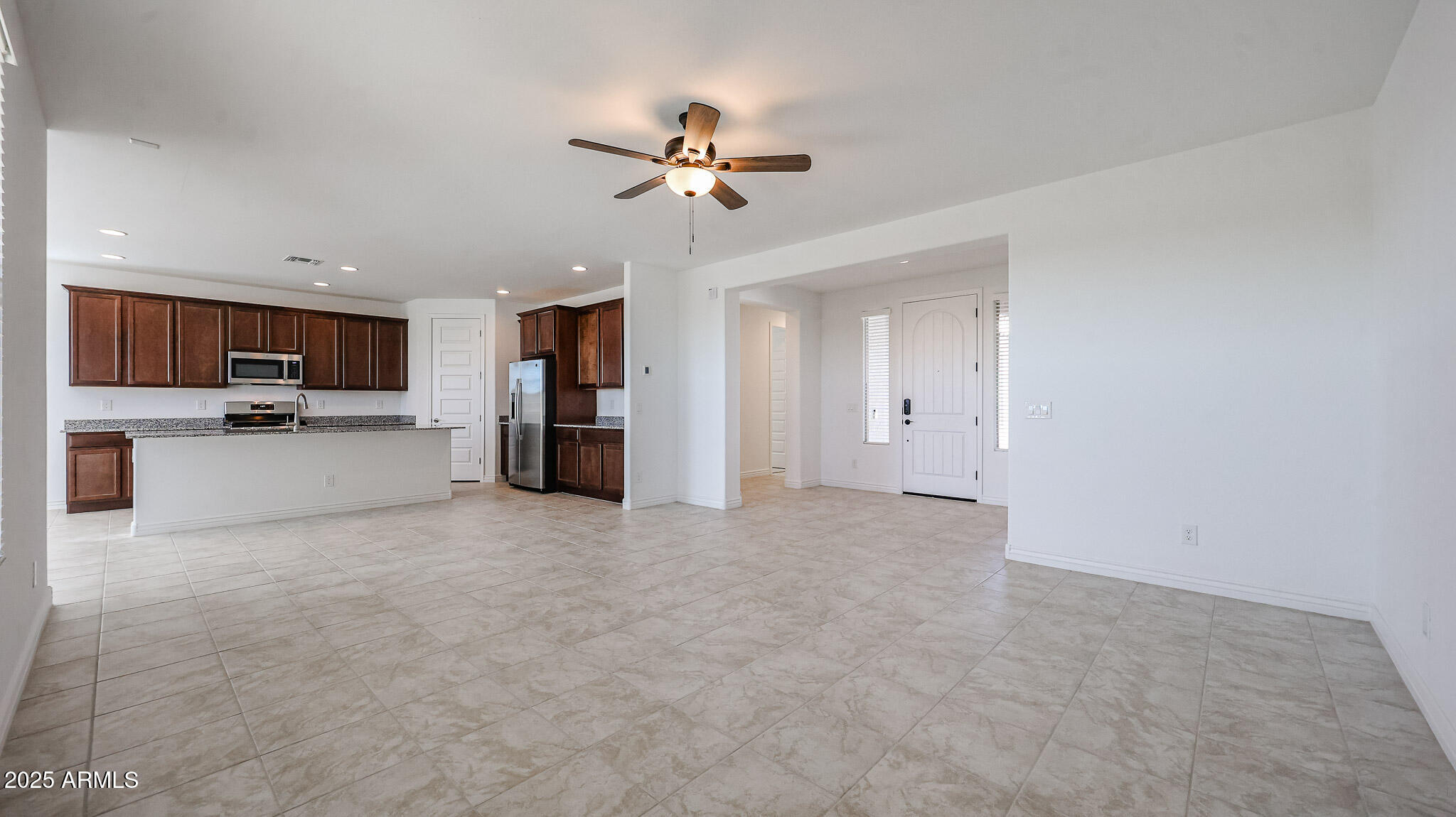 25051 North 171st Avenue Surprise, AZ 85387 - Photo 5 of 19 a view of a kitchen with a sink and a refrigerator