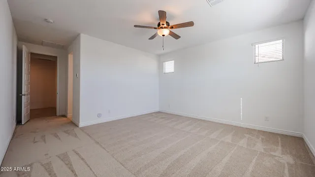 a view of an empty room with a ceiling fan