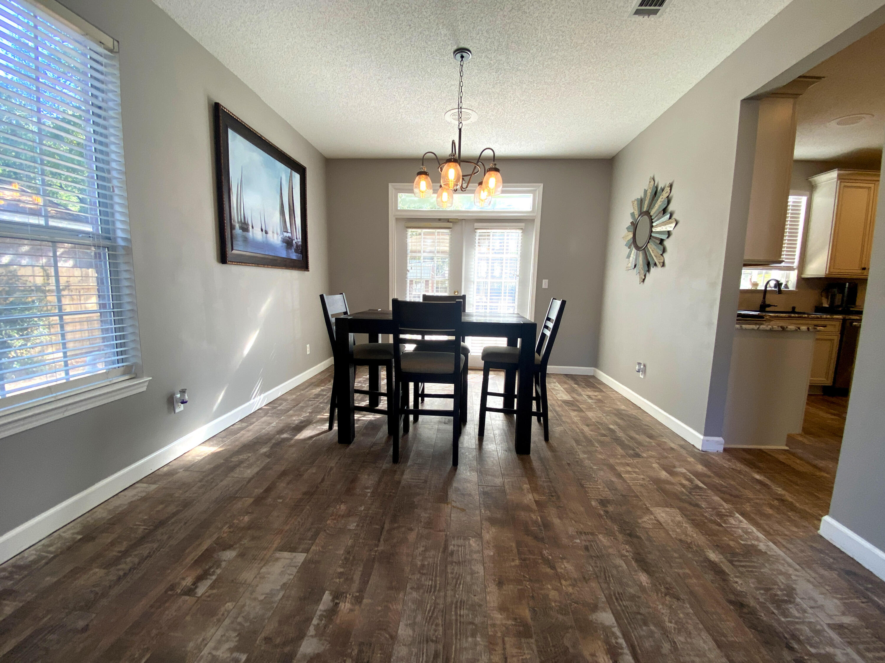 4466 Kingslynn Road Niceville, FL 32578 - Photo 12 of 77 a view of a dining room with furniture window and wooden floor