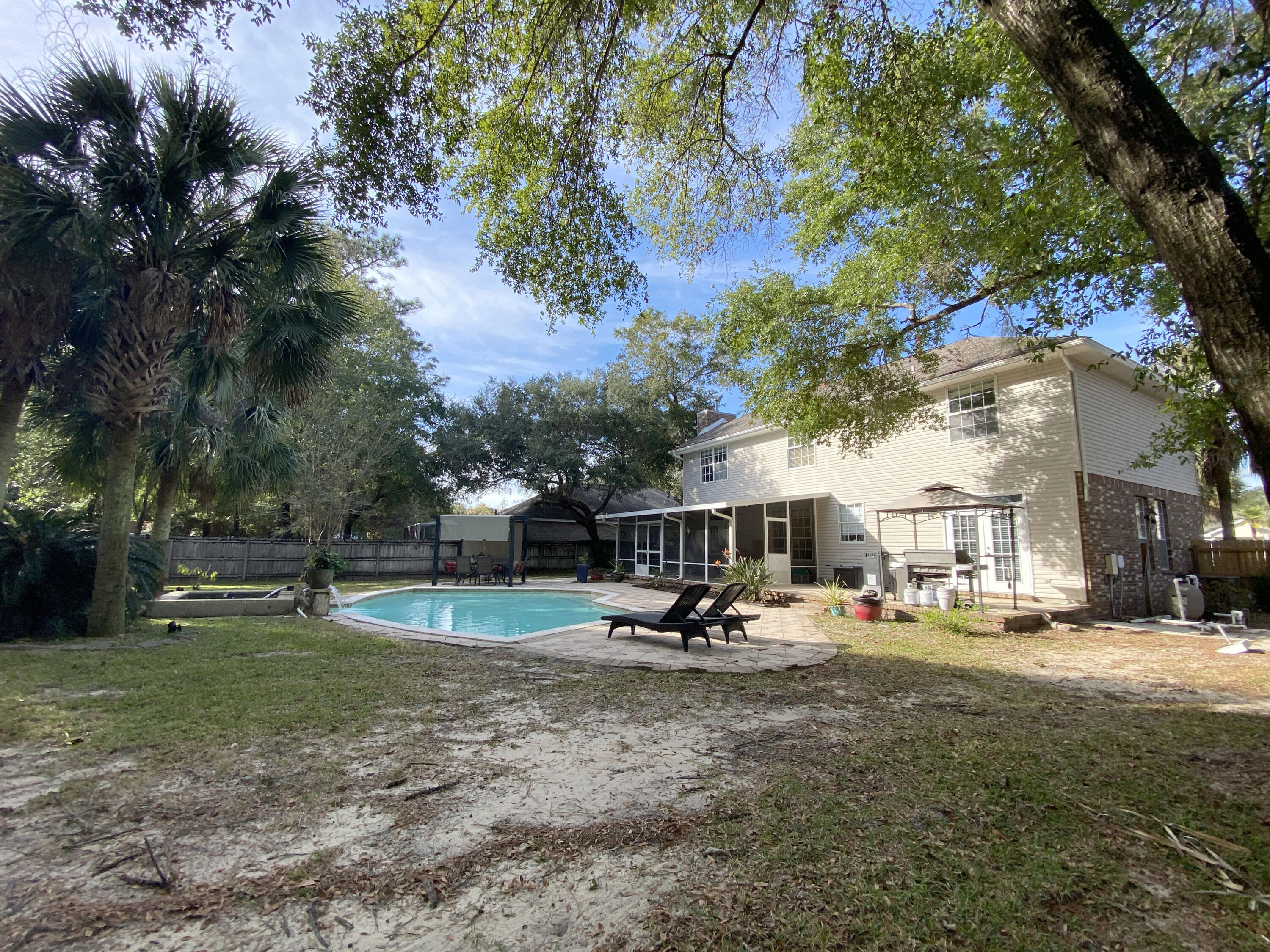 4466 Kingslynn Road Niceville, FL 32578 - Photo 64 of 77 a view of a park with swings and slides
