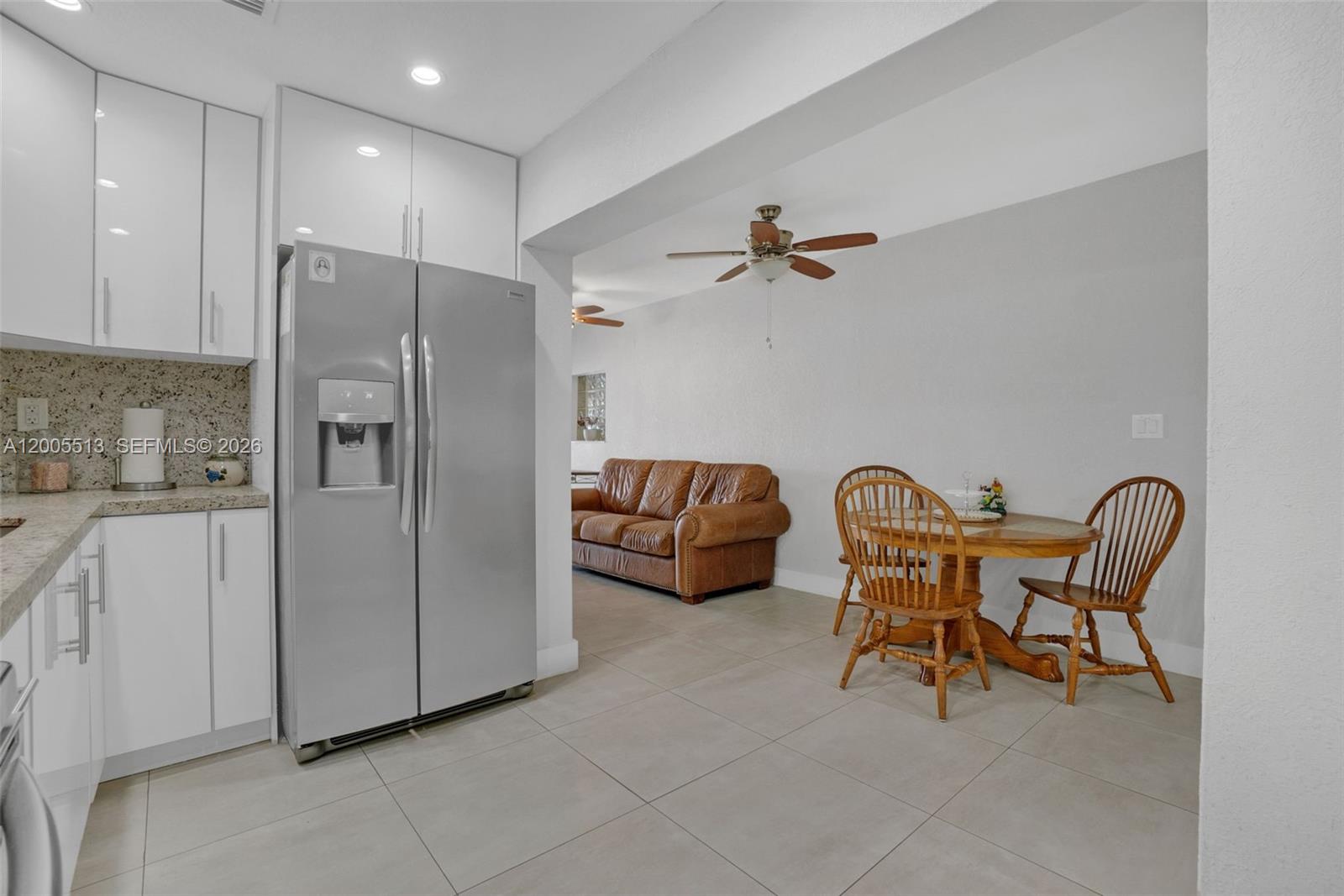 862 West 79th Street Hialeah, FL 33014 - Photo 11 of 34 a kitchen with stainless steel appliances a refrigerator and a table