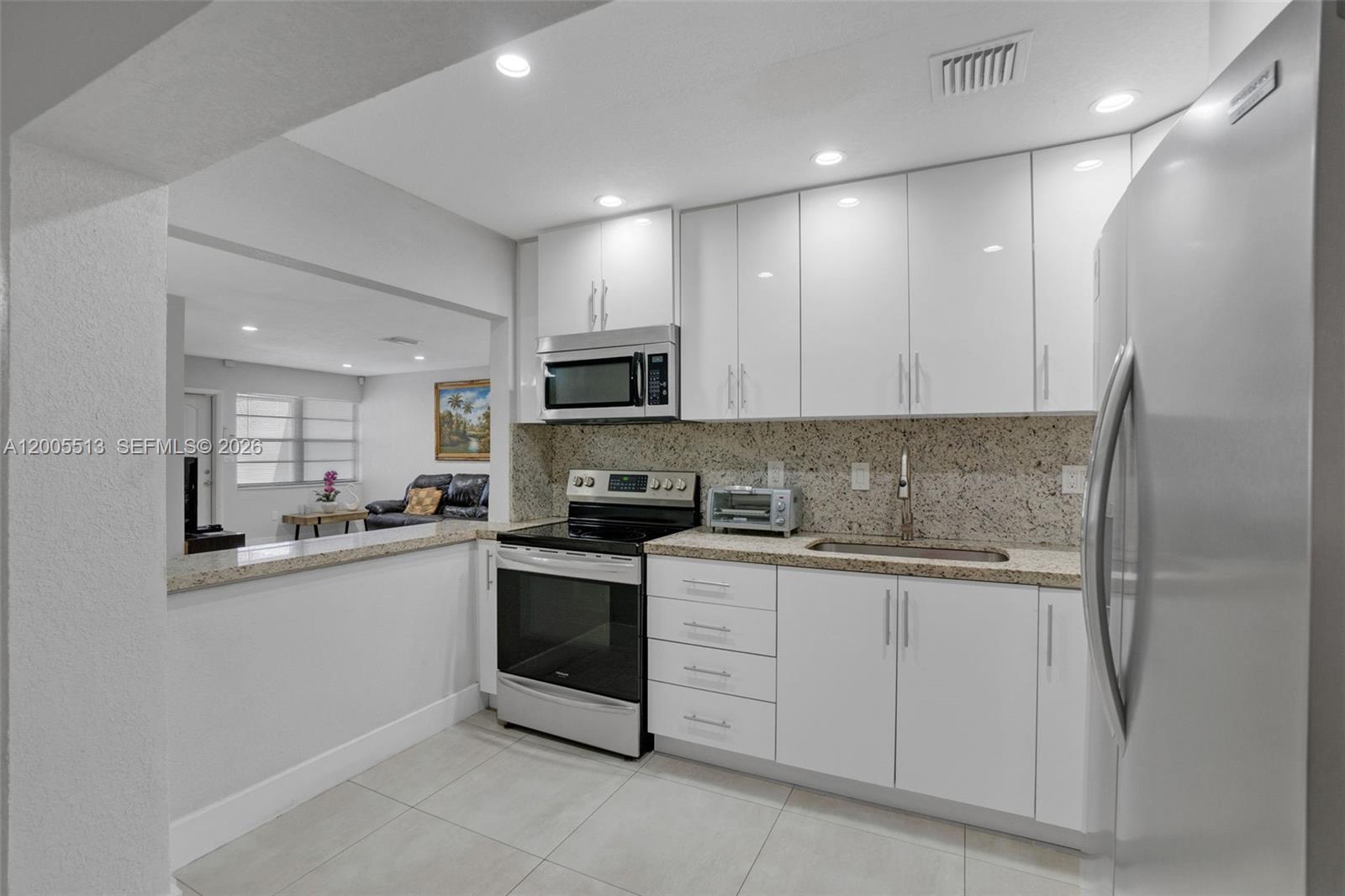 862 West 79th Street Hialeah, FL 33014 - Photo 14 of 34 a kitchen with granite countertop cabinets stainless steel appliances and a sink