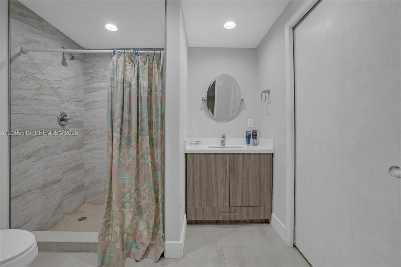 862 West 79th Street Hialeah, FL 33014 - Photo 20 of 34 a bathroom with a shower a sink and a mirror