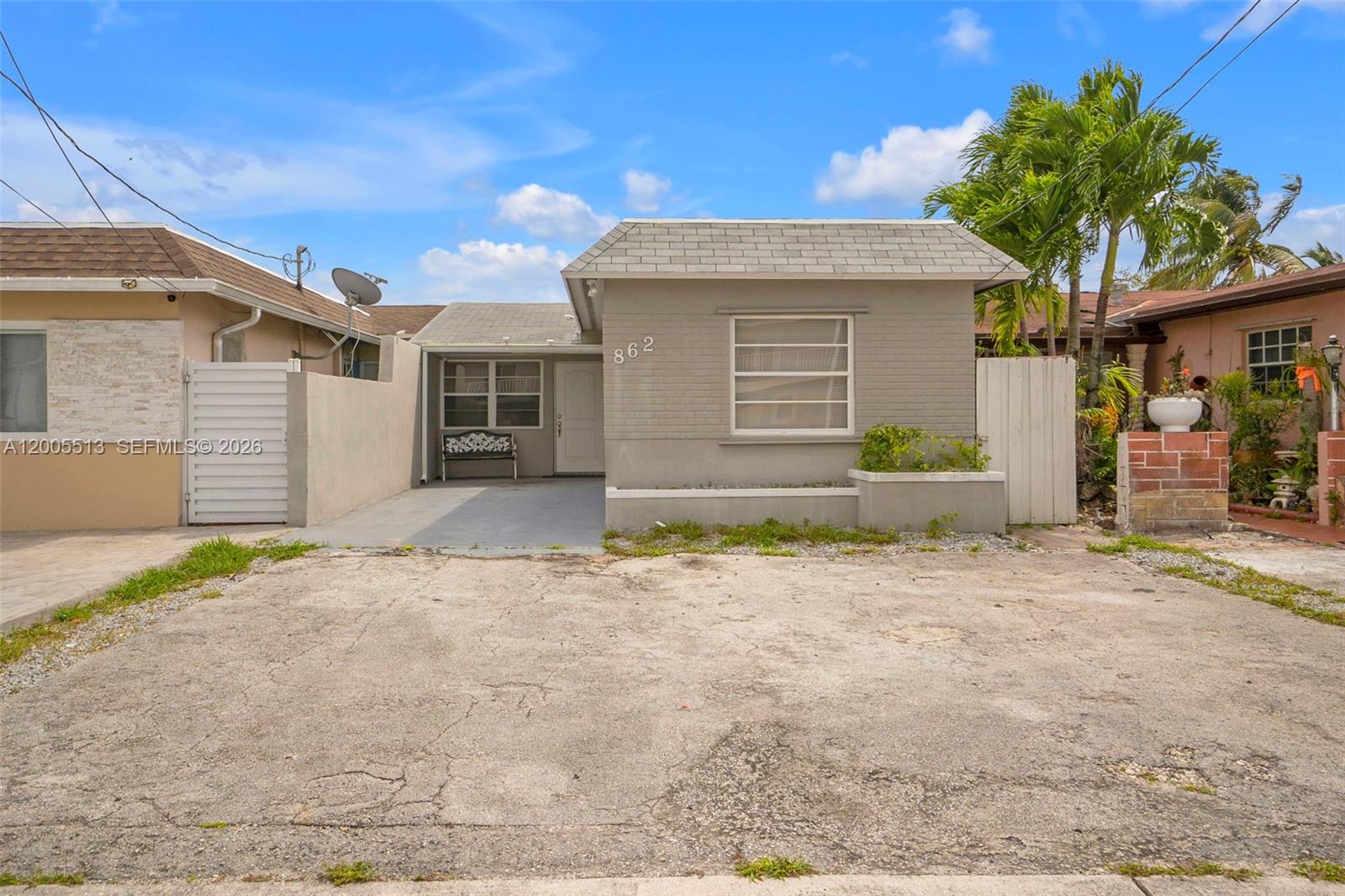 862 West 79th Street Hialeah, FL 33014 - Photo 2 of 34 a front view of a house with a yard and garage