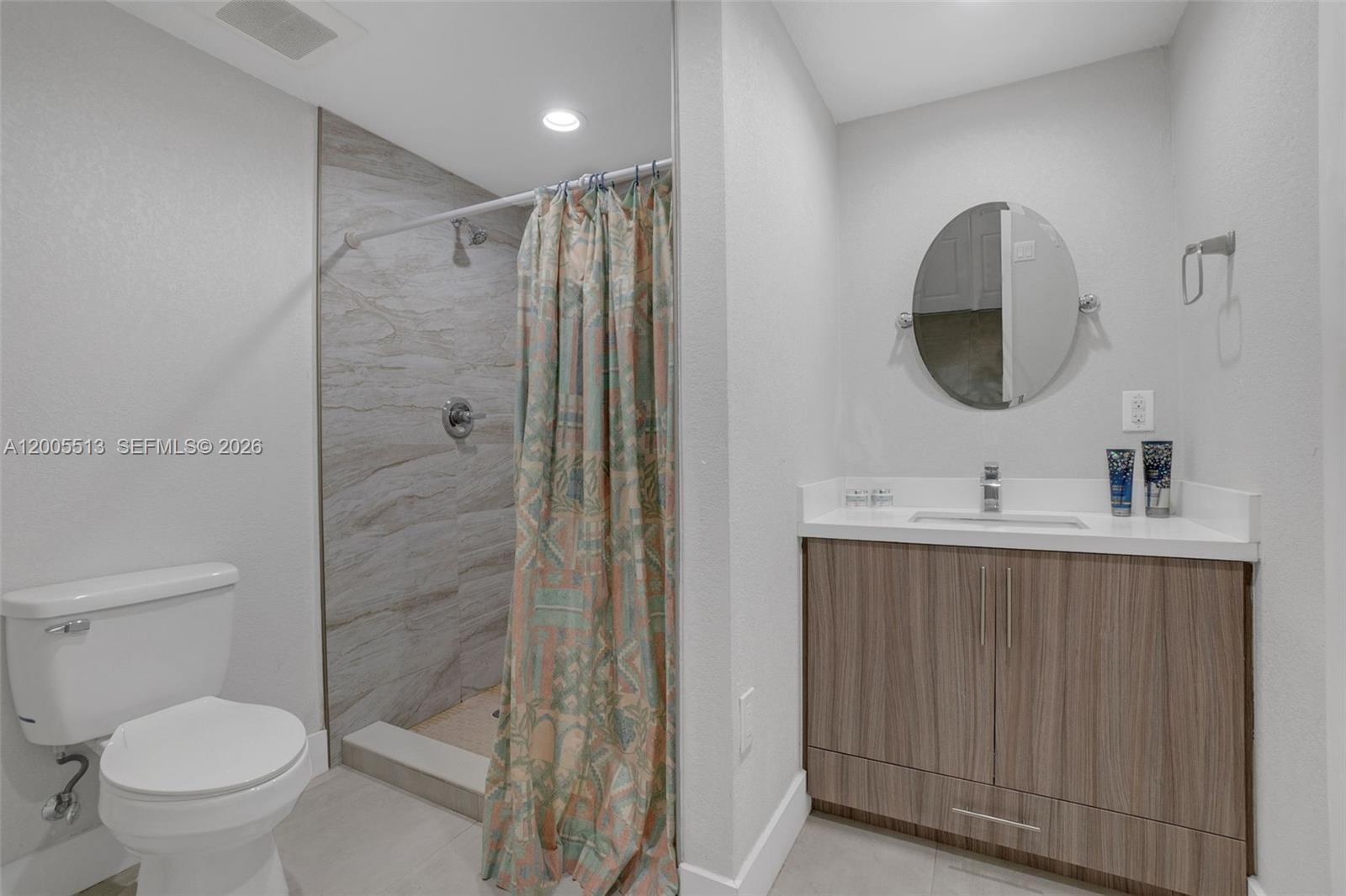 862 West 79th Street Hialeah, FL 33014 - Photo 21 of 34 a bathroom with a toilet sink and mirror