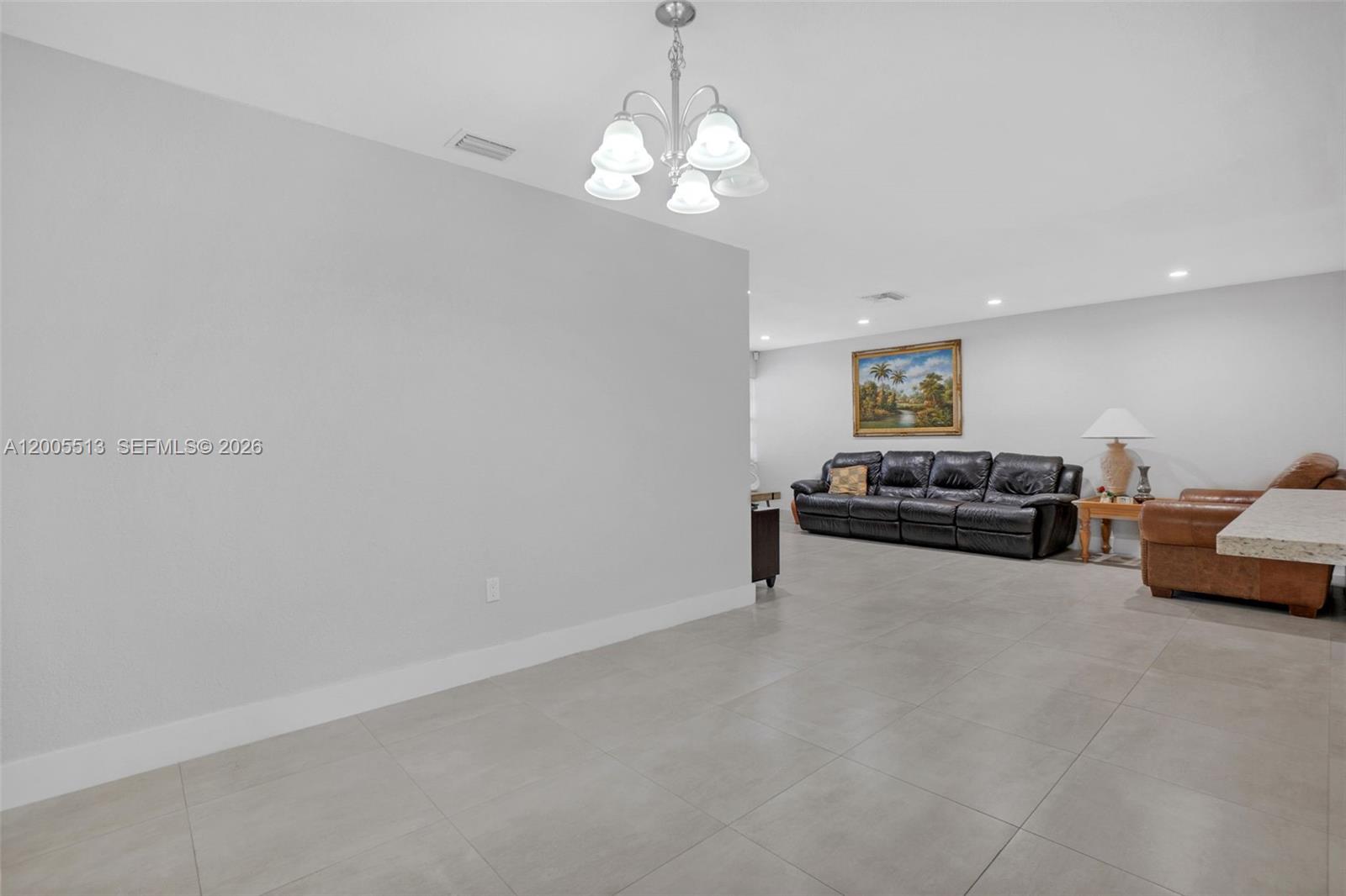 862 West 79th Street Hialeah, FL 33014 - Photo 7 of 34 a living room with furniture and a chandelier