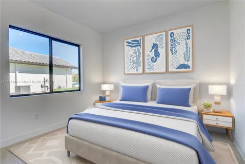 a bedroom with a bed and a painting on the wall