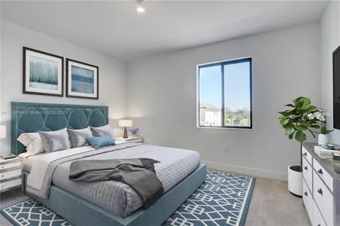 a bedroom with a bed and a lamp on dresser